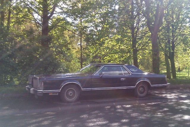 Dark blue Lincoln Continental Mark VI parked roadside