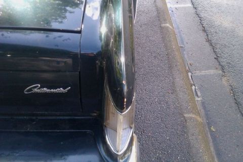 1991 Ford LTD Crown Victoria - Close-up of the rear of a Continental, showing script and chrome fender detail.