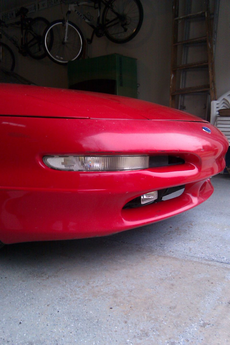 Red 1996 Ford Probe front bumper with clear turn signal and fog light