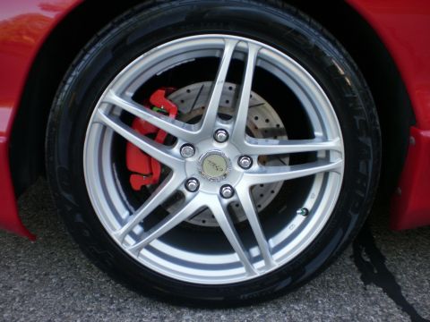 1996 Ford Probe - Close-up of a red car's wheel silver rims and bright red brake calipers.