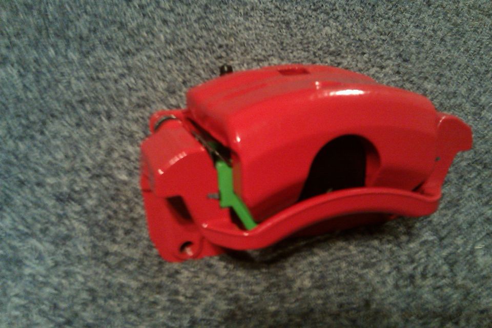 Red powder coated, rebuilt Mazda6 calipers loaded with green stuff brake pads.