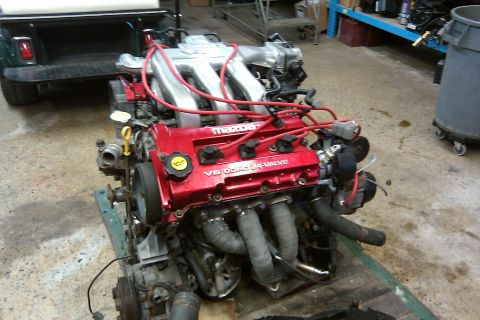 1996 Ford Probe - Engine with red valve covers and silver intake manifold is on a stand.