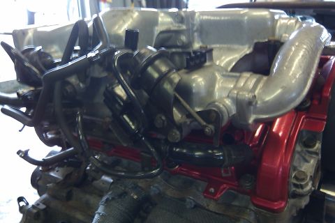 1996 Ford Probe - Close-up view of an engine's intake manifold and valve cover assembly.