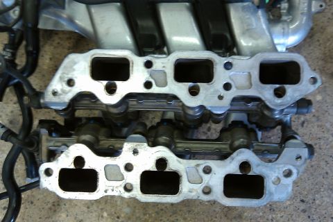 1996 Ford Probe - Close-up of an engine intake manifold, showing the ports and fuel injector assembly.