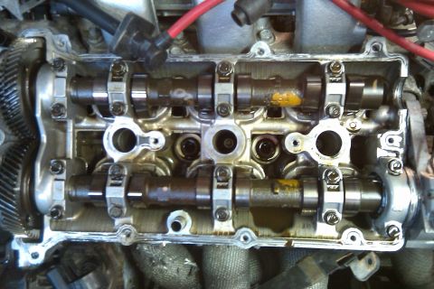 1996 Ford Probe - Engine internals exposed during a KLZE teardown, revealing camshafts and oil residue.