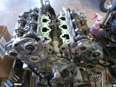 1996 Ford Probe - Disassembled V6 engine showing internal components like camshafts and timing gears.