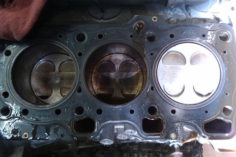 1996 Ford Probe - Close-up view of an engine's cylinder block and pistons, showing wear and tear.