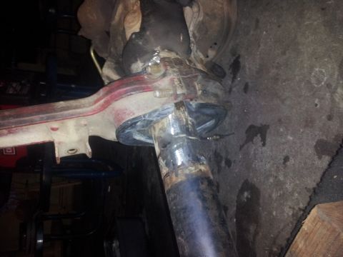 1978 Ford Bronco - This image shows a close-up view of a vehicle's suspension system, focusing on a metal component with visible welding.