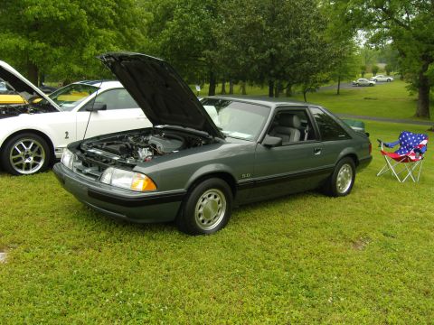2007 Ford Mustang - A 1987 Ford Mustang GT is parked on grass with its hood open, alongside another car.