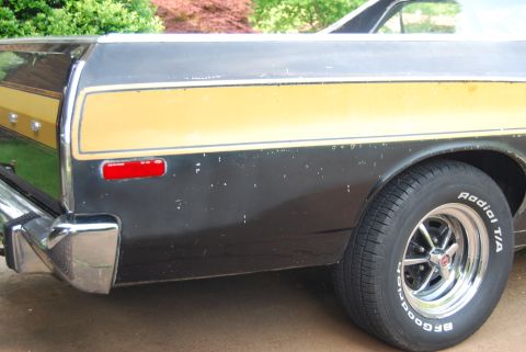 1975 Ford Ranchero - Rear view of a 1975 Ford Ranchero showing its distinctive side stripe and chrome bumper.