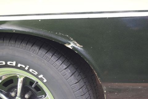 1975 Ford Ranchero - Close-up of damage to the rear fender of a 1975 Ford Ranchero.