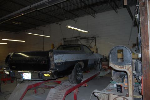 1975 Ford Ranchero - This vehicle is on a lift in a workshop, showing its rear end and a license plate.