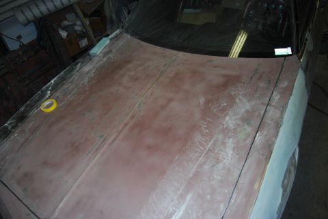 1975 Ford Ranchero - The car's hood and fender are prepped for paint, with yellow tape visible on the hood's edge.