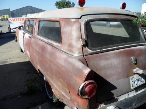1994 Jeep Cherokee - This heavily rusted station wagon, possibly a hearse or ambulance conversion, is seen from the rear with a visible license plate.