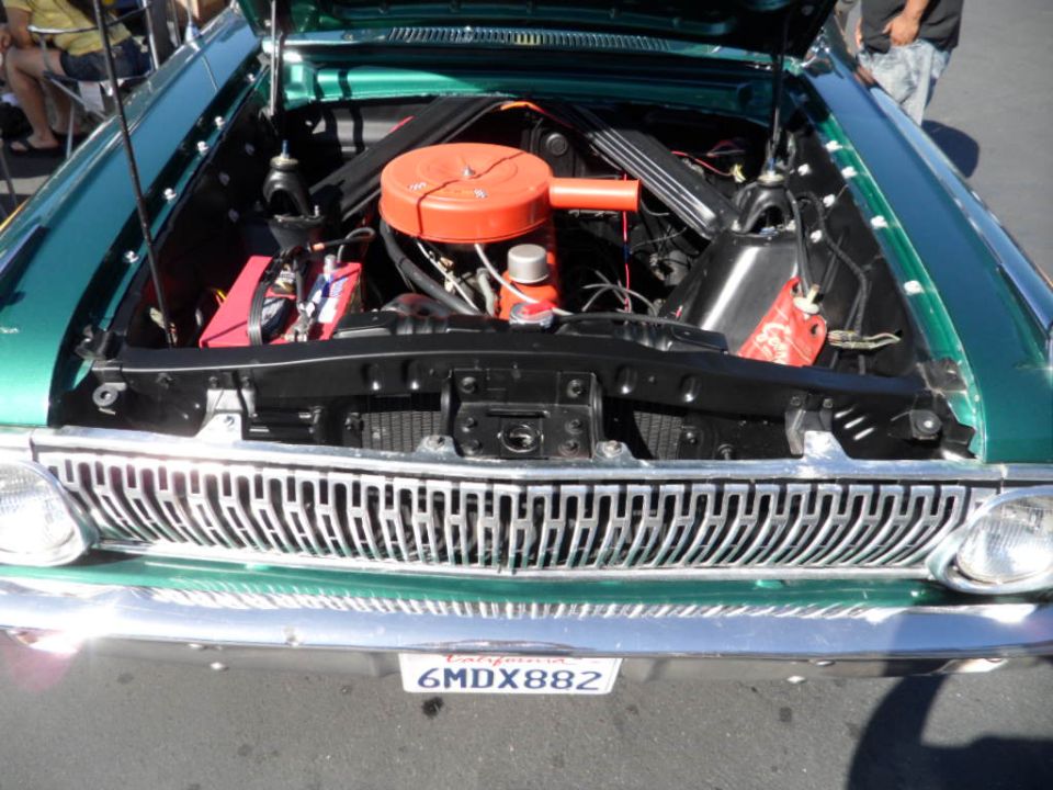 Green classic car engine bay with orange air cleaner and chrome grille