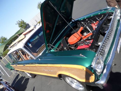 1994 Jeep Cherokee - A vintage green woody station wagon is displayed with its hood open, revealing the engine compartment.