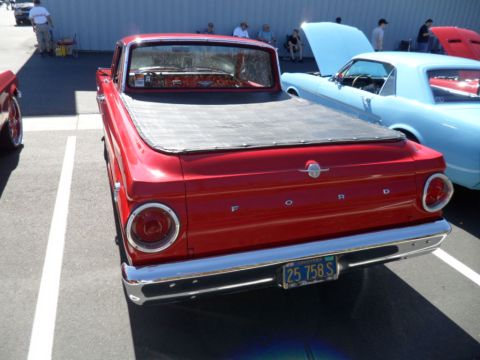 1994 Jeep Cherokee - Red 1960 Ford Falcon Ranchero pickup truck parked at an outdoor car show.