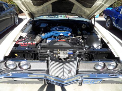 1994 Jeep Cherokee - Front view of a classic car's engine bay, revealing a blue air filter and chrome accents.
