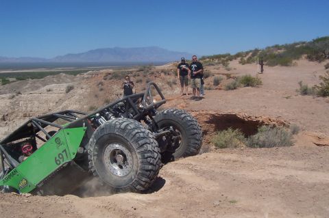 1981 Ford F-150 - Custom off-road buggy tackles a challenging desert terrain, with spectators observing the action.