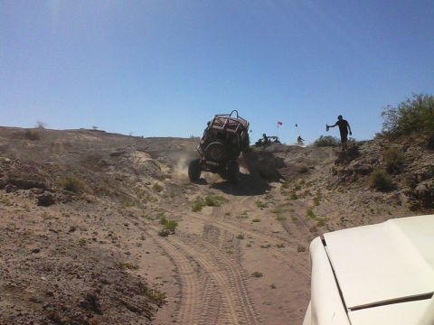 1981 Ford F-150 - Off-road vehicles navigate a challenging sandy terrain under a clear blue sky.