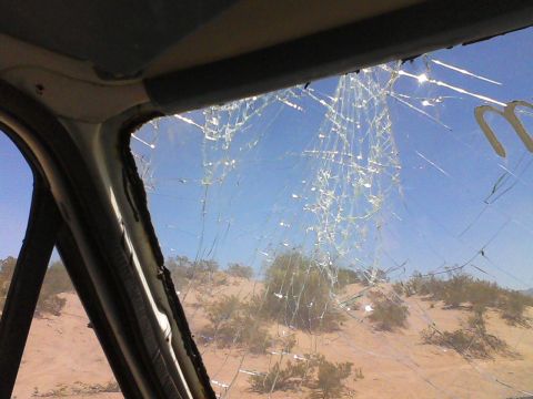 1981 Ford F-150 - Desert landscape seen through a heavily cracked windshield.