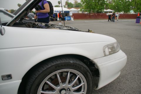 1993 Ford Taurus - Front quarter view of a white 1993 Ford Taurus showing the fender, wheel, and tire.