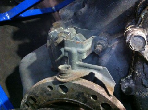 1990 Ford Bronco - This image shows a close-up view of an engine component and a brake rotor, likely during a repair or rebuild process.