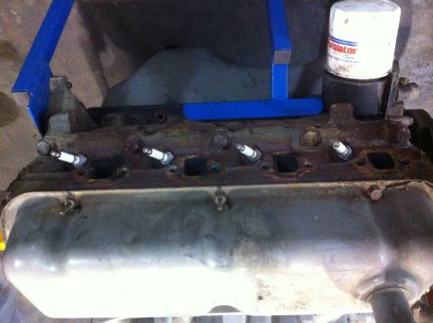 1990 Ford Bronco - Engine block with spark plugs and oil filter, likely undergoing maintenance or rebuild.
