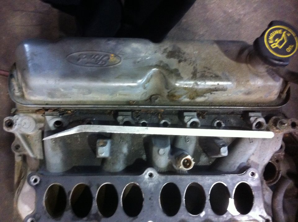 Ford oval logo on valve cover, engine oil cap visible