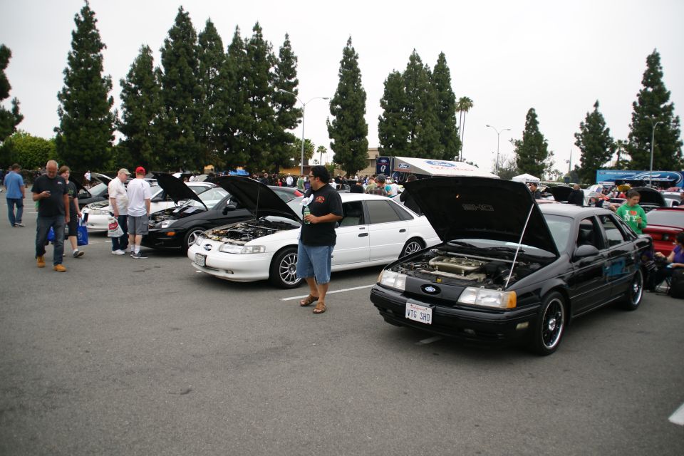 Black 1993 Ford Taurus 3q-front view, hood open, showing engine