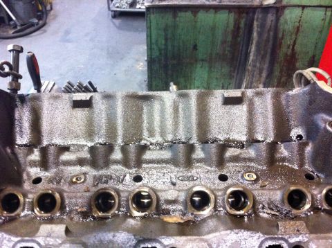 1990 Ford Bronco - This is a close-up view of an engine block, likely undergoing some form of repair or rebuild.