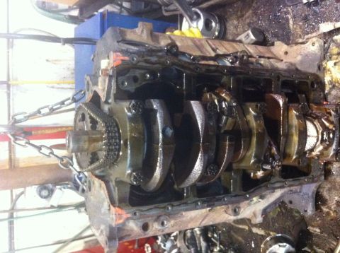 1990 Ford Bronco - Engine block assembly showing crankshaft, connecting rods, and timing chain.