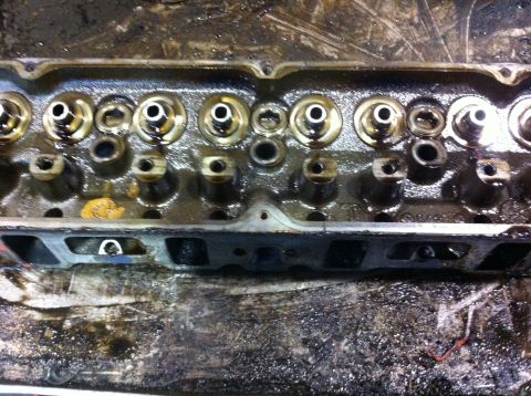 1990 Ford Bronco - Close-up view of an engine cylinder head, showing valves and springs.