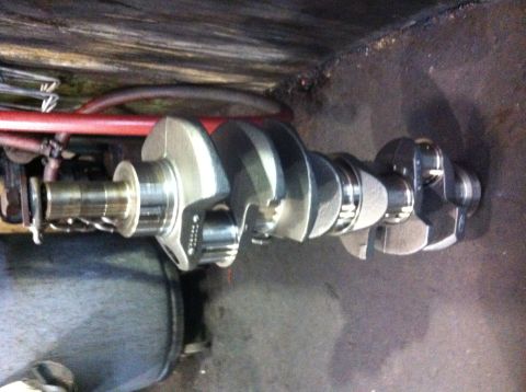 1990 Ford Bronco - Close-up view of a crankshaft, possibly for a 351W engine build, with some part numbers visible.