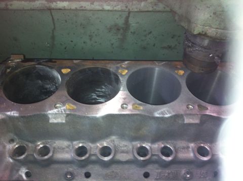 1990 Ford Bronco - The engine block's cylinders are visible, with some showing signs of wear and machining.