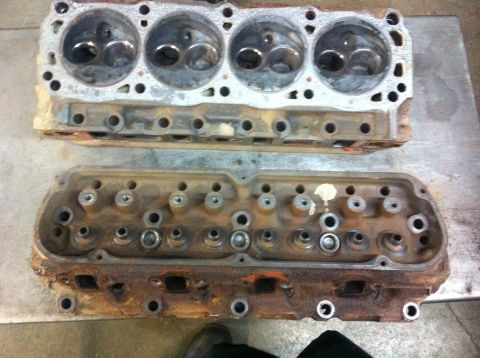 1990 Ford Bronco - Two engine cylinder heads are shown, one above the other, with visible combustion chambers and valve stems.