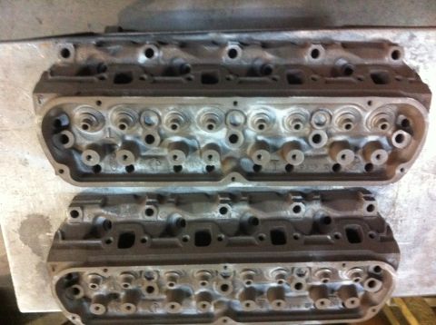 1990 Ford Bronco - A pair of engine cylinder heads are laid out, likely for a rebuild or upgrade project.
