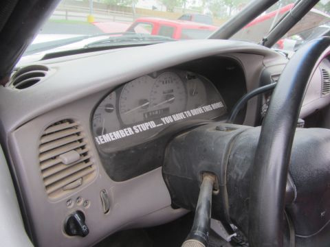 1964 Ford Ranchero - Car interior shows dashboard and steering column with a humorous sticker.