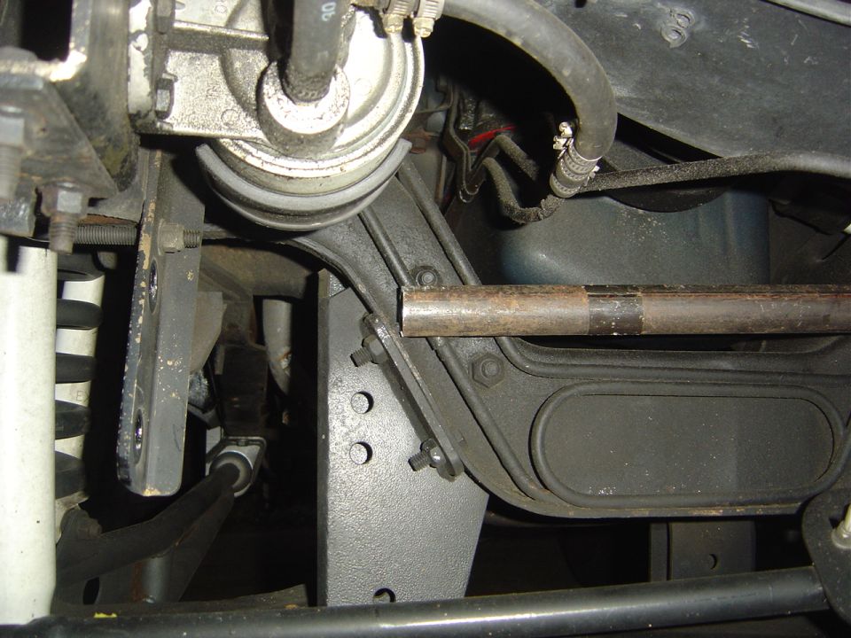 Close-up of vehicle's steering box bracket and suspension parts