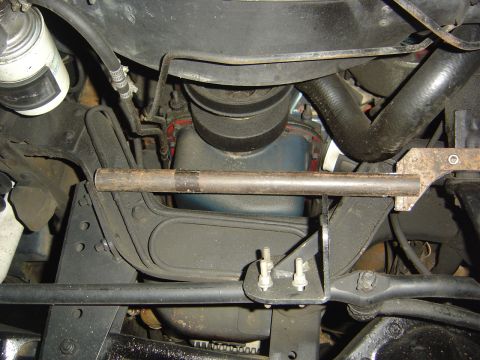 1986 Ford Bronco - Underside view of the steering box bracket and engine components on a 1986 Ford Bronco.