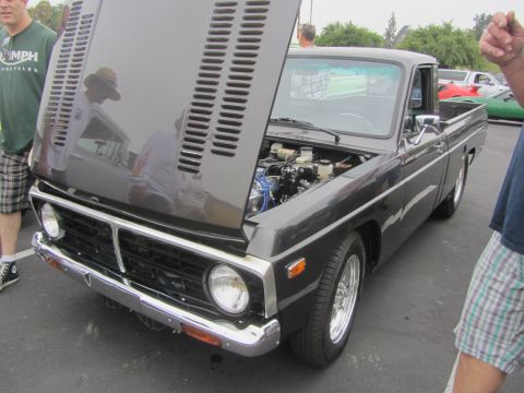 1964 Ford Ranchero - This dark gray pickup truck, likely a 1972 model, is displayed with its hood open, revealing the engine compartment.