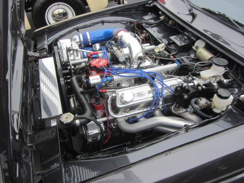 1964 Ford Ranchero - Engine bay features a chrome Ford Motorsport engine with a blue intake and red spark plug wires.