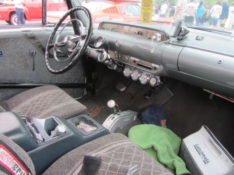 1964 Ford Ranchero - The interior of a 1964 Ford Ranchero features custom gauges and a floor shifter, with a Lunchmate cooler visible.
