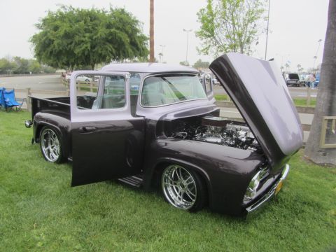 1964 Ford Ranchero - This customized pickup truck features a two-tone paint job and exposed engine components.