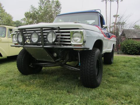 1964 Ford Ranchero - A modified 1967 Ford pickup truck with a custom bumper and lights sits on a grassy field.
