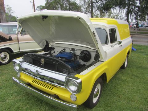 1964 Ford Ranchero - A two-tone yellow and white panel van is parked on grass with its hood open, revealing the engine compartment.