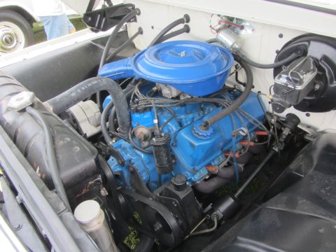 1964 Ford Ranchero - Close-up view of a vehicle's engine bay, a blue painted engine and air cleaner assembly.