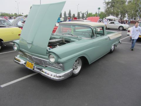 1964 Ford Ranchero - A light green and cream 1957 Ford Ranchero is displayed with its hood open, revealing the engine compartment.