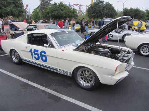 1964 Ford Ranchero - A white 1965 Ford Mustang GT350 race car is parked with its hood open, displaying the engine bay.