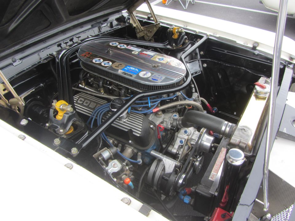 Engine bay with a V8 engine, chrome air cleaner, and blue spark plug wires